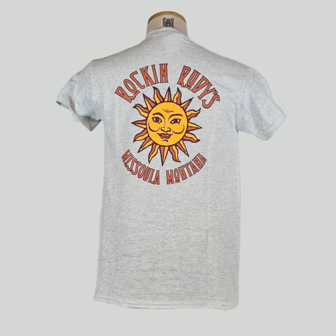 Heathered gray colored t-shirt with large sun in center with "ROCKIN RUDY'S" & "MISSOULA, MONTANA" encircling it.