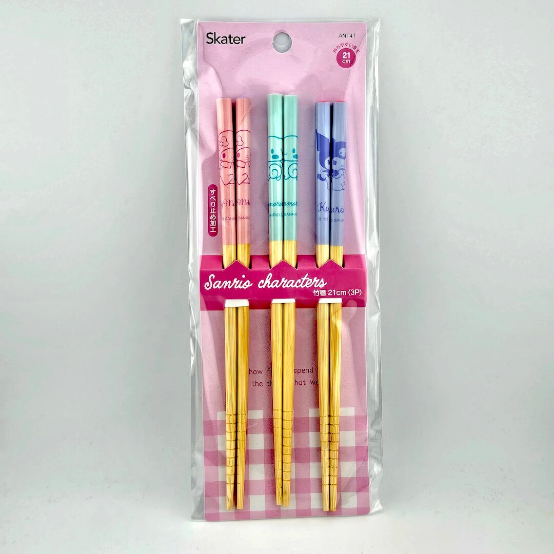 Pink packaging for three sets of chopsticks against white background.