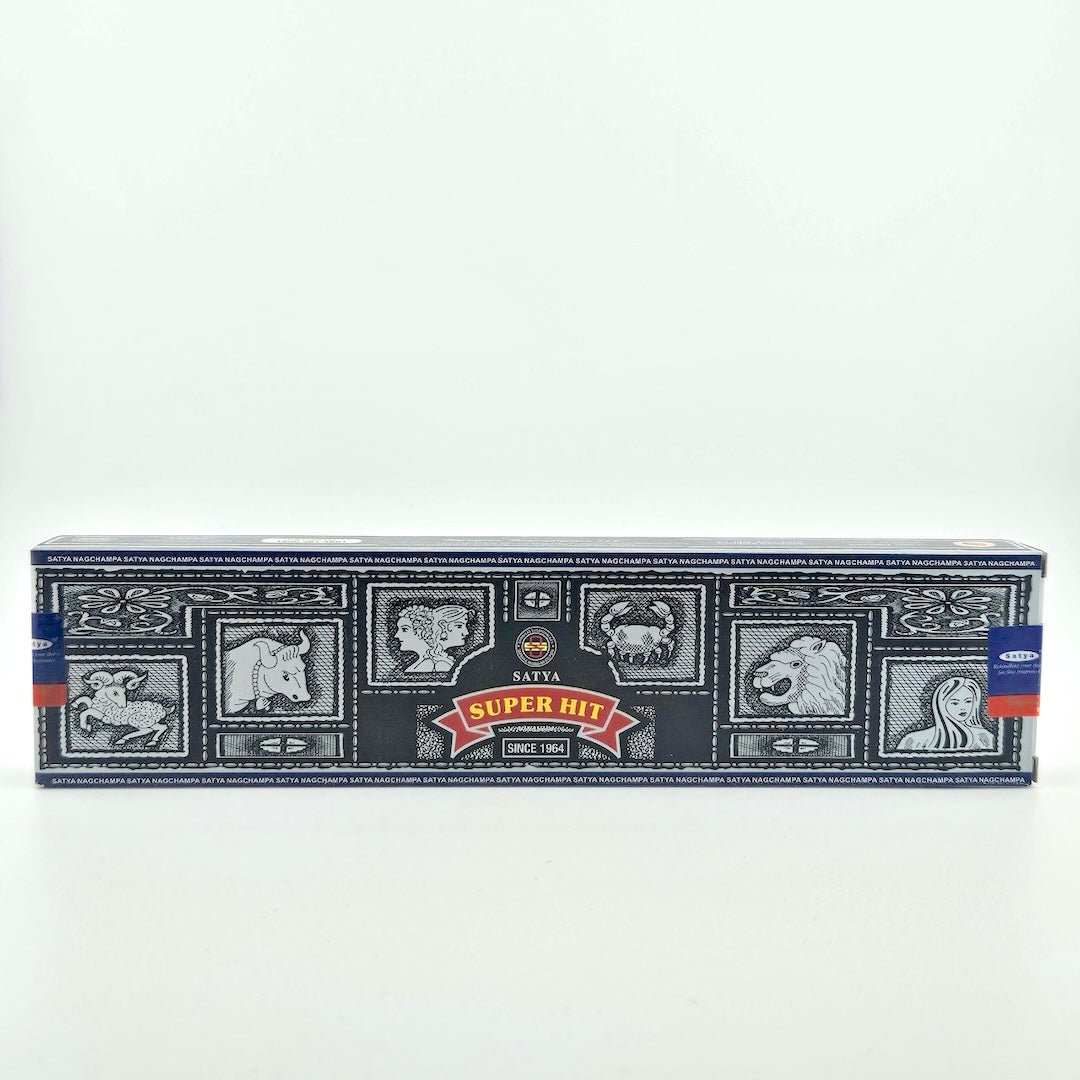 Black box with tile motif, red banner with scent name at center under company name.