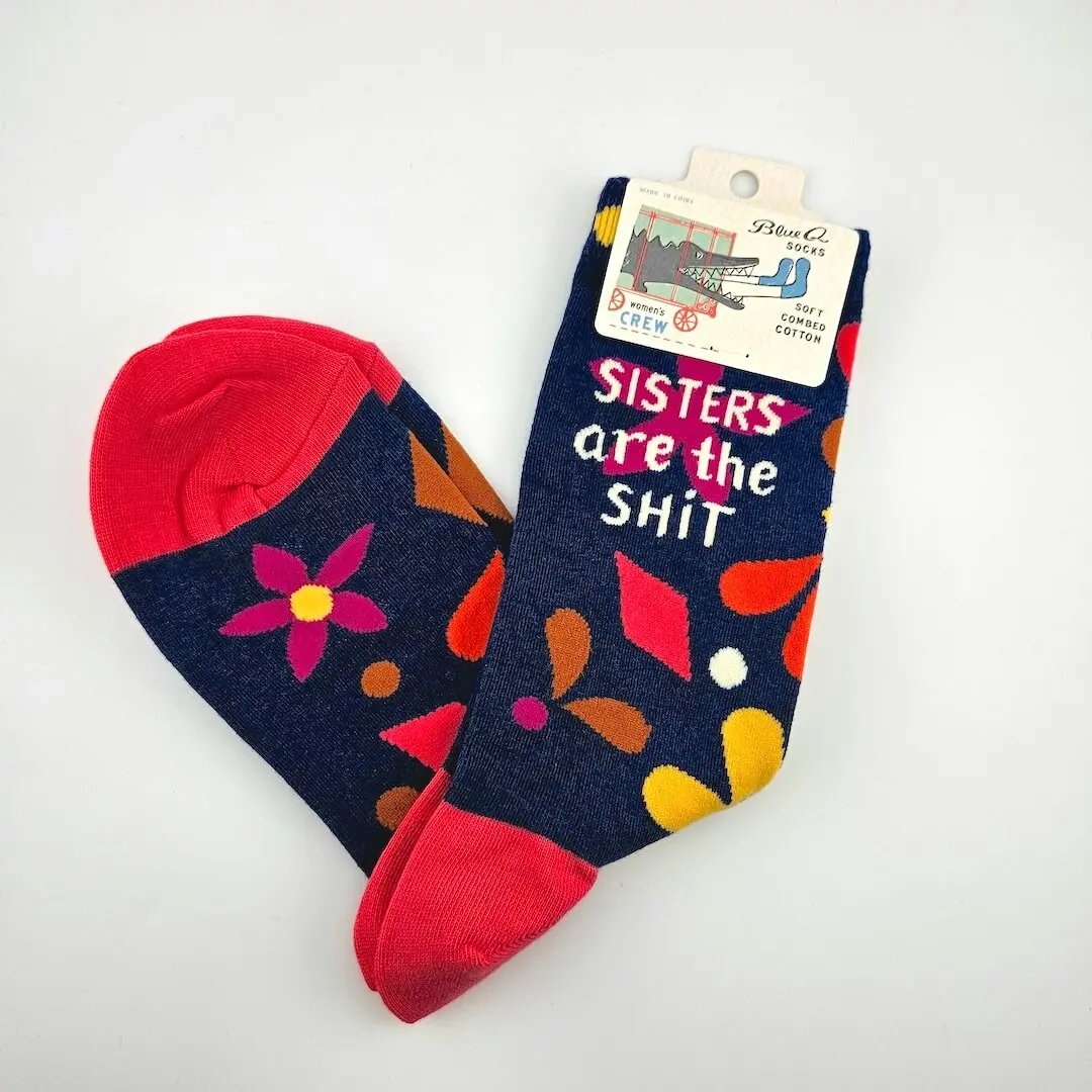 Colorful socks with floral patterns and text on a white background