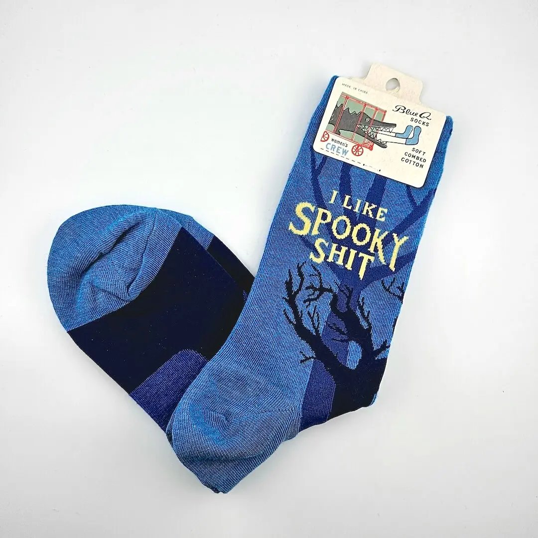 Blue socks with text and a tree design, displayed on a white background
