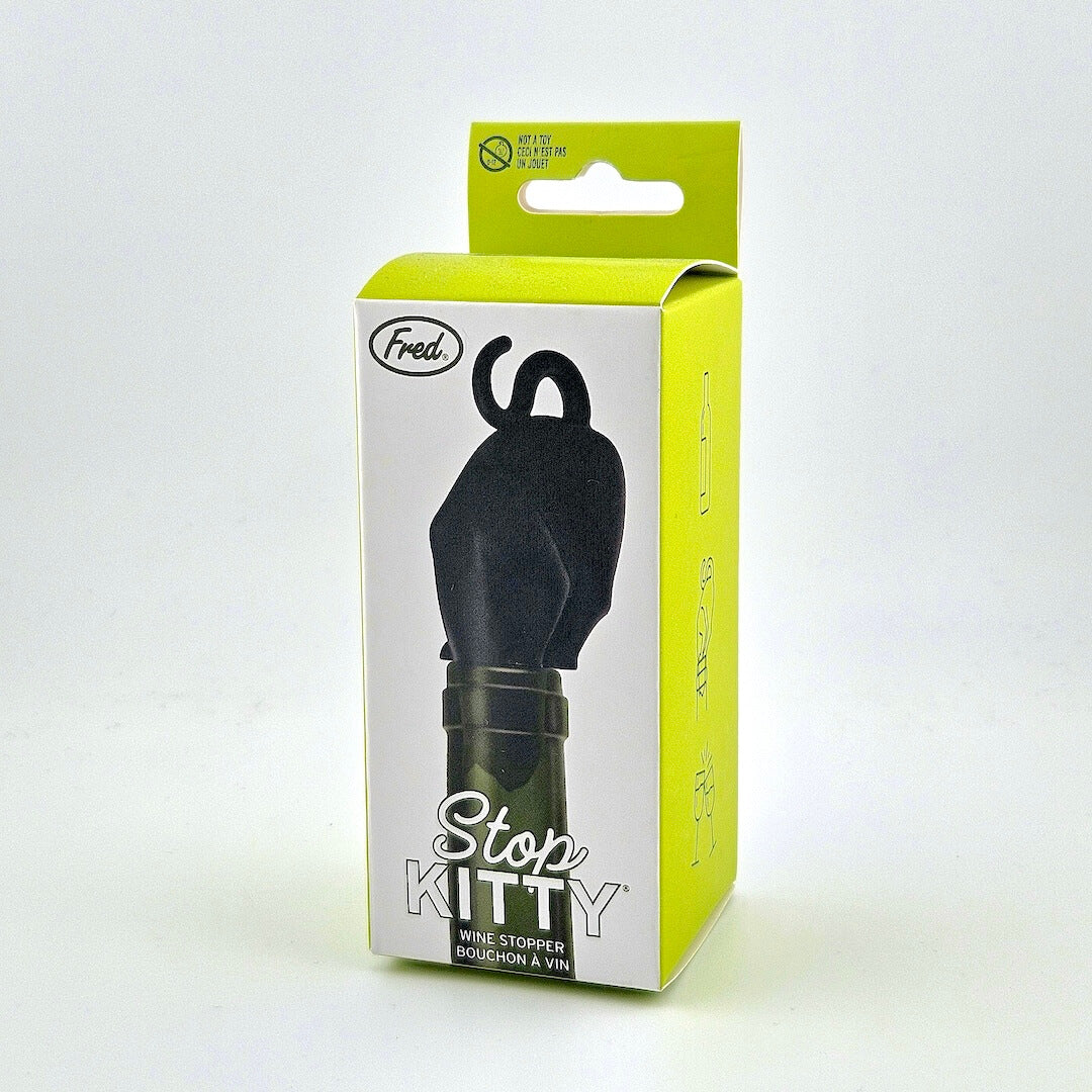 green packaging for cat shaped wine stopper against white background.