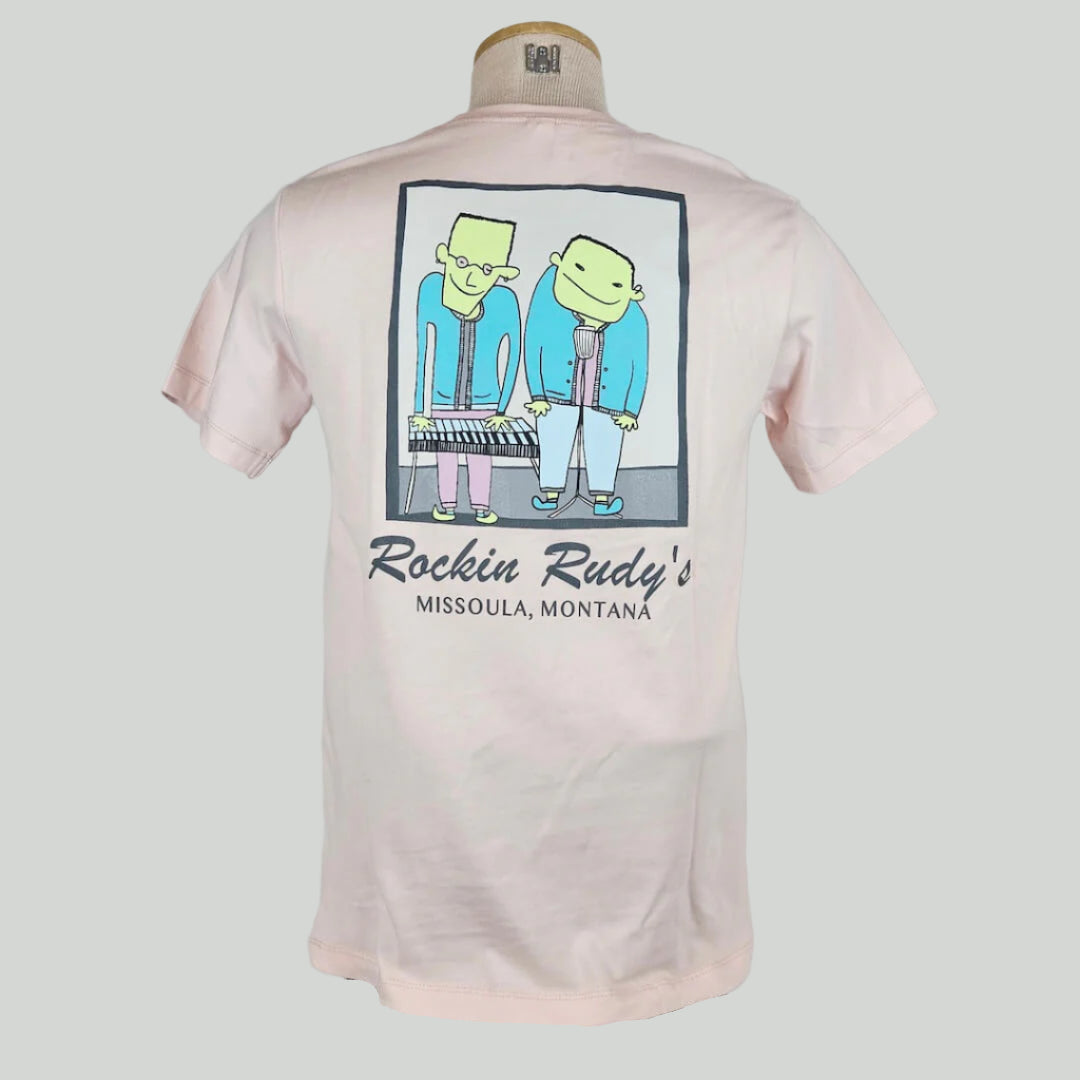 Pink t-shirt with two guys in square, one is playing keyboard, the other in front of a microphone. Below graphic is store & location name.
