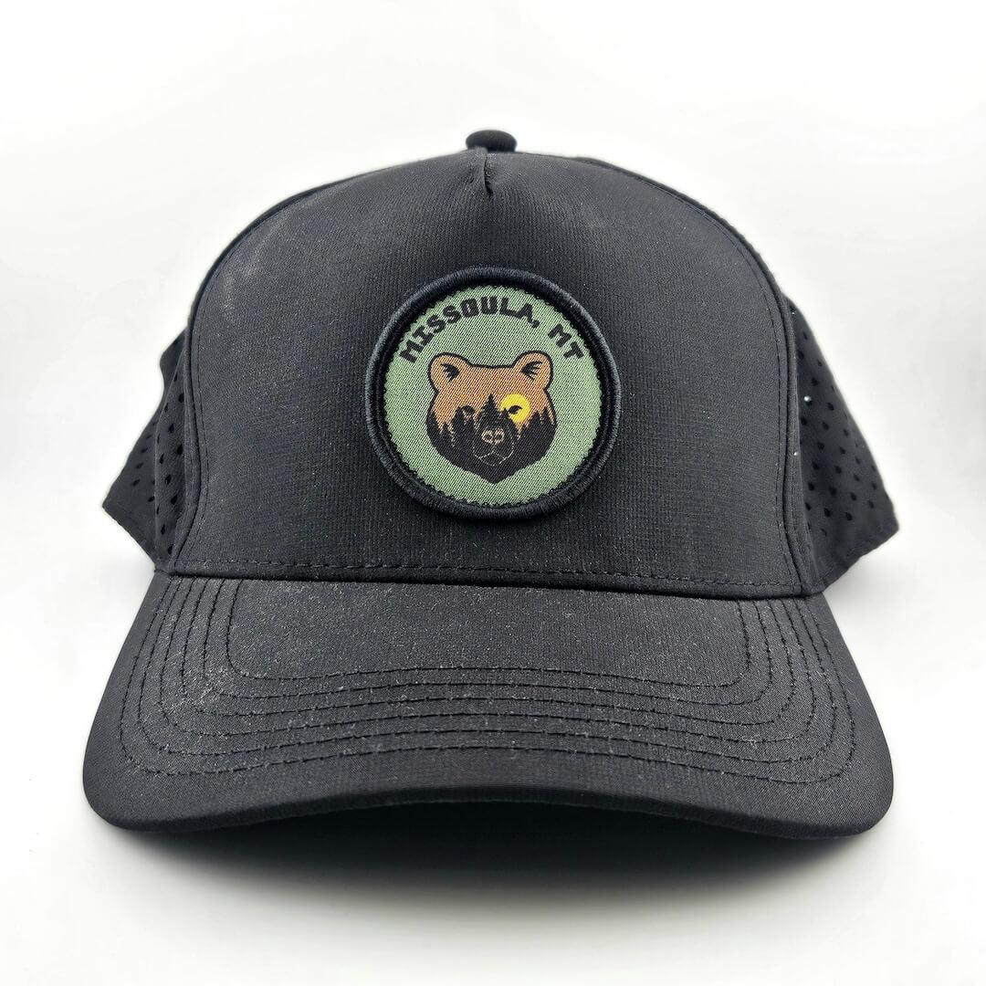 Black cap with a bear emblem and text on a white background