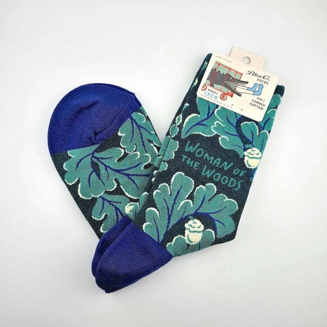 Pair of socks with leaf pattern and blue accents on a white background