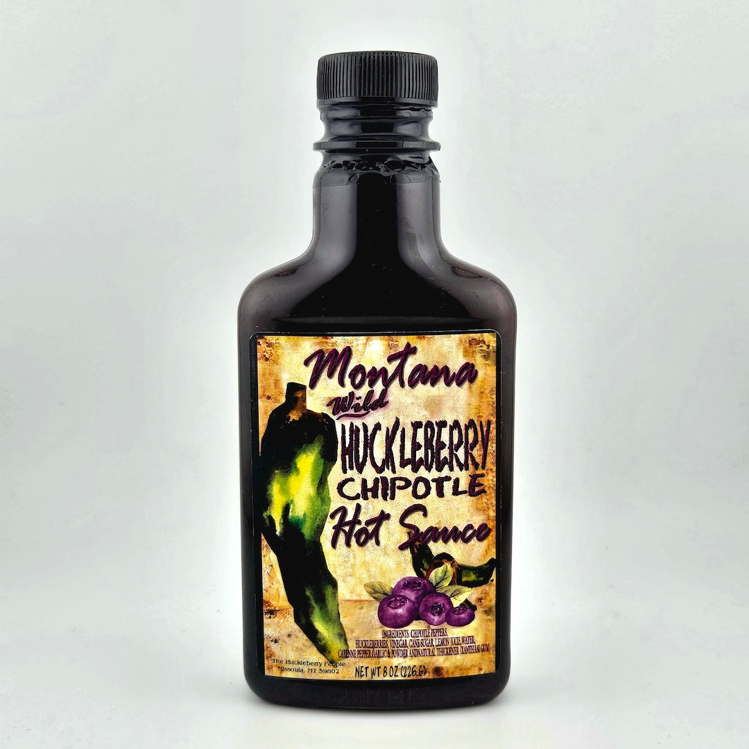 Bottle of Montana Wild Huckleberry Chipotle Hot Sauce on a white background