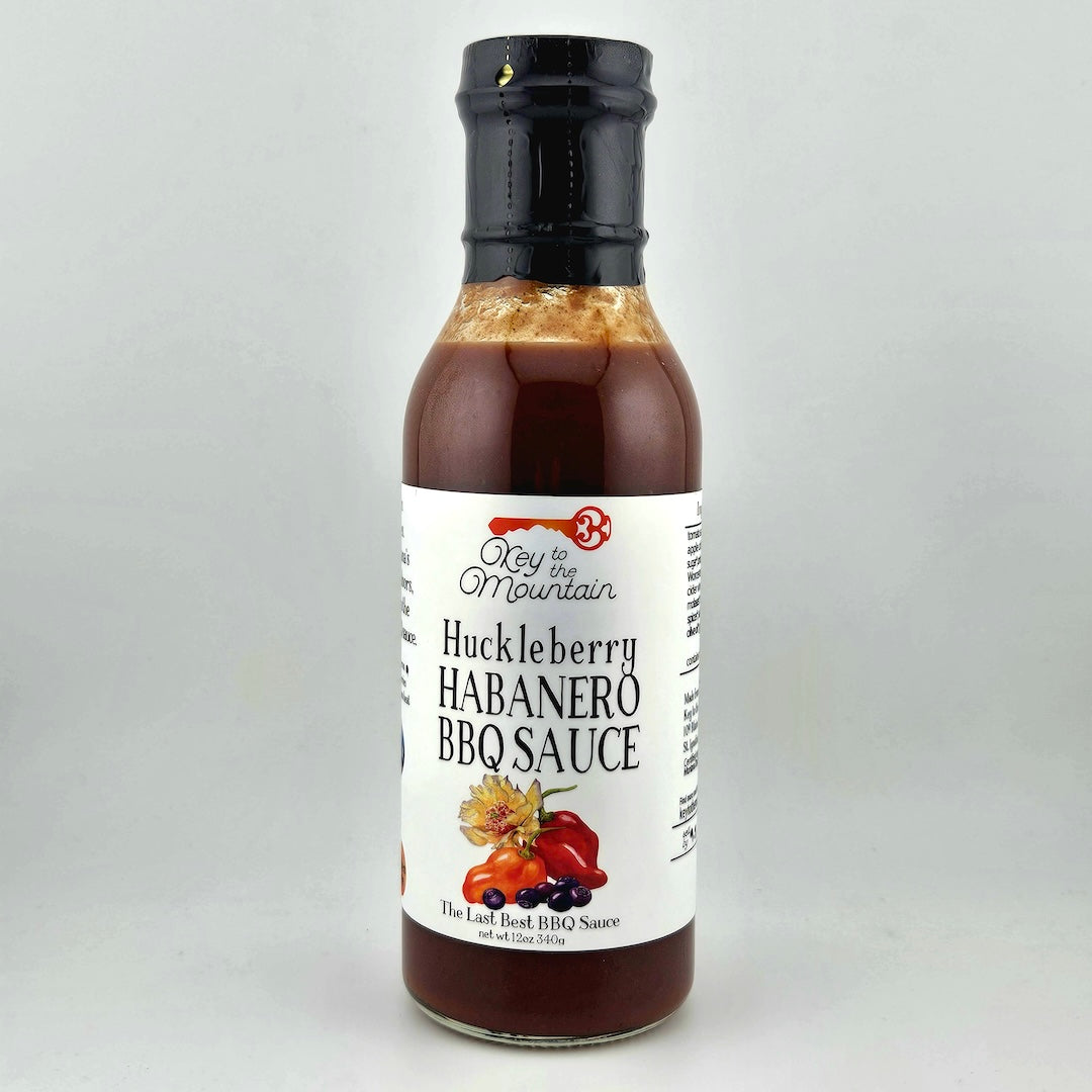 Bottle of Huckleberry Habanero BBQ Sauce on a gray background