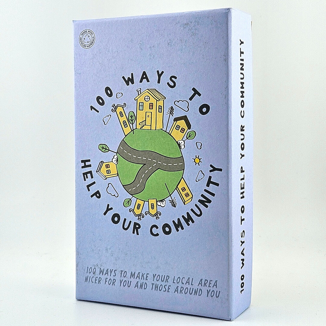 Purple box of cards titles "100 Ways to Help Your Community" with house and globe illustrations against white background.
