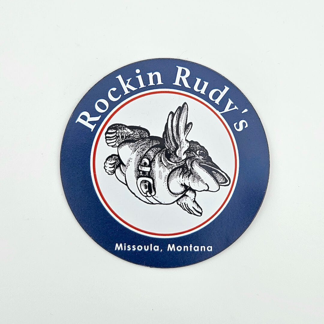 Round magnet with 'Rockin Rudy's' branding and a fish illustration on a white background