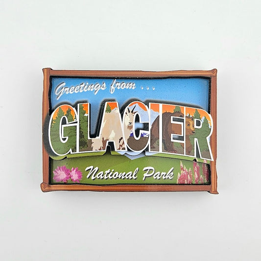 Fridge magnet with 'Greetings from Glacier National Park' text and scenic illustrations on a white background