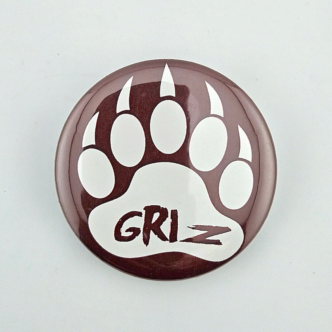 Button badge magnet with bear paw print and 'GRIZ' text on a white background