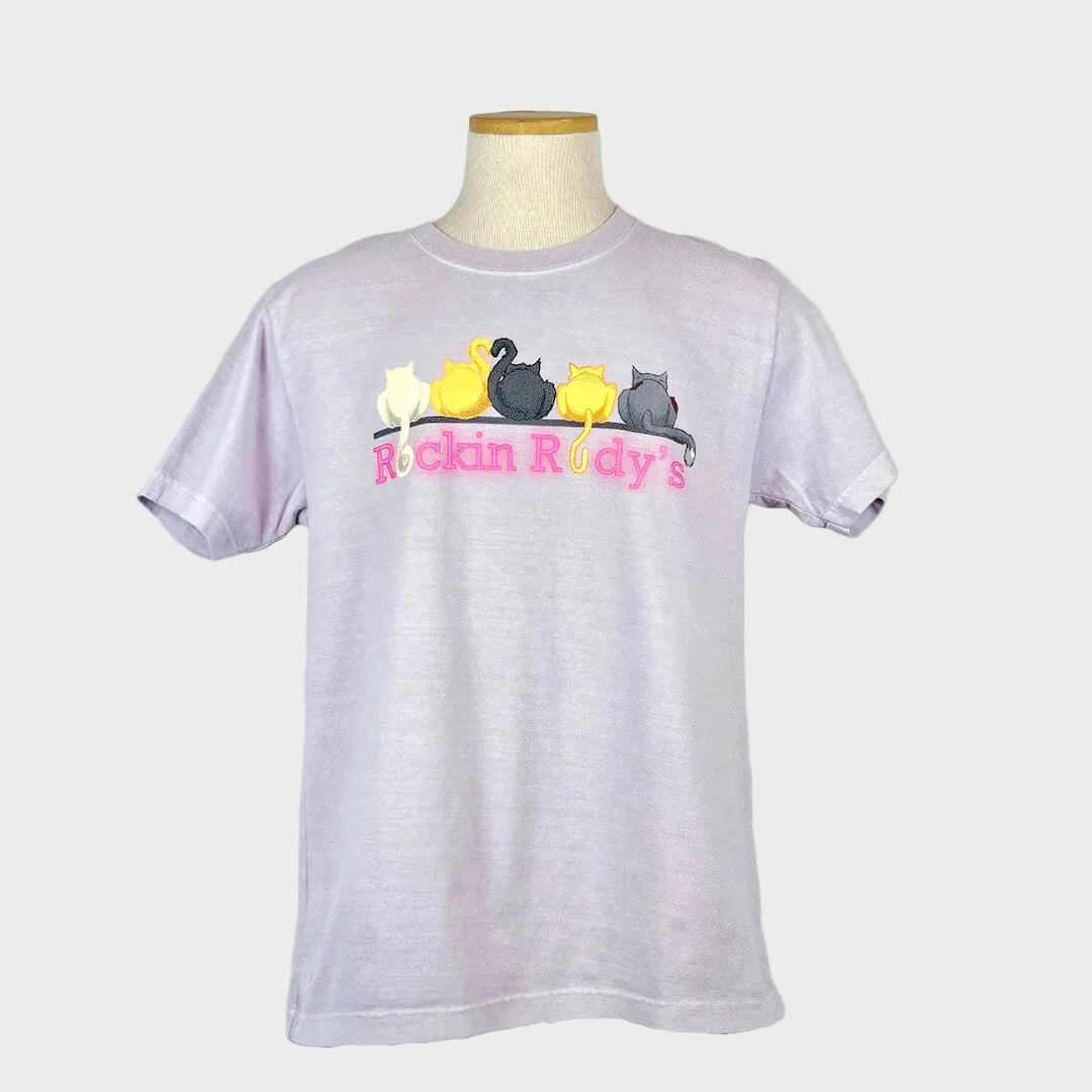 Light purple t-shirt with colorful duck design and 'Rockin Rudy's' text on a mannequin against a white background