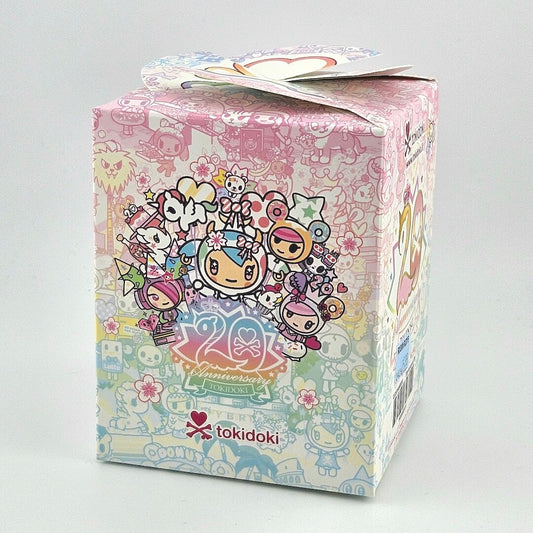 Brightly colored packaging for blind box unicorn figure against gray background. 