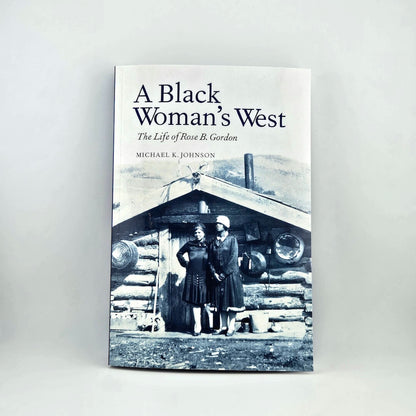 Book cover of 'A Black Woman's West' with a black and white photo of two women in front of a log cabin.