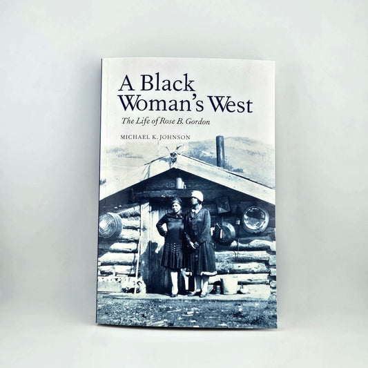 Book cover of 'A Black Woman's West' with a black and white photo of two women in front of a log cabin.