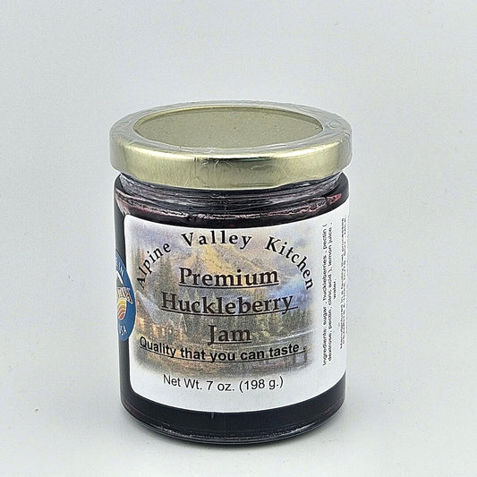 Glass jar with gold lid. White label has mountain cabin landscape in background of printed product info.