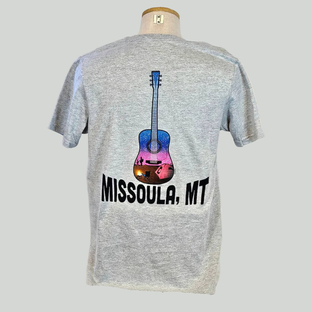 Gray t-shirt with a colorful guitar graphic and 'Missoula, MT' text on a mannequin against a white background