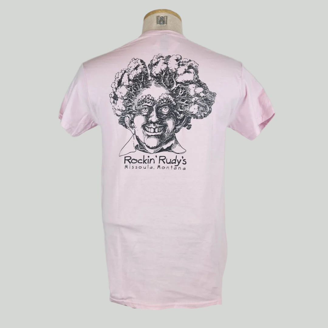Pink shirt with large smiling man’s head with trees for hair, "Rockin Rudy's, Missoula, Montana," printed below in center.