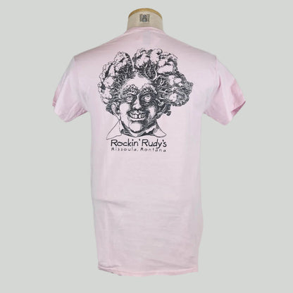 Pink shirt with large smiling man’s head with trees for hair, "Rockin Rudy's, Missoula, Montana," printed below in center.