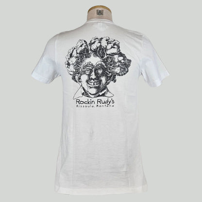 White shirt with large smiling man’s head with trees for hair, "Rockin Rudy's, Missoula, Montana," printed below in center.