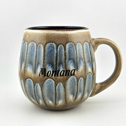 Ceramic mug with textured design and 'Montana' text on a white background