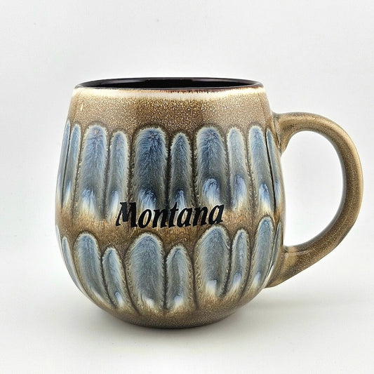 Ceramic mug with textured design and 'Montana' text on a white background