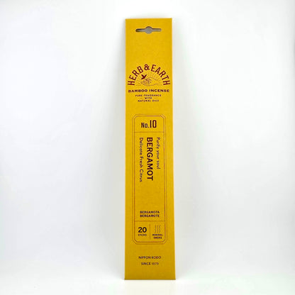 Golden yellow rectangular package of incense with brown text describing product. 