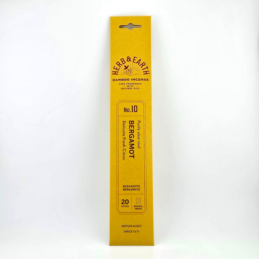 Golden yellow rectangular package of incense with brown text describing product. 