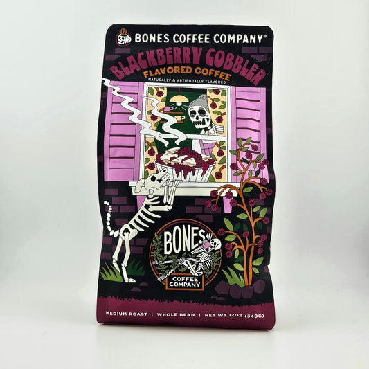 Coffee package from Bones Coffee Company with blackberry cobbler flavor on a white background