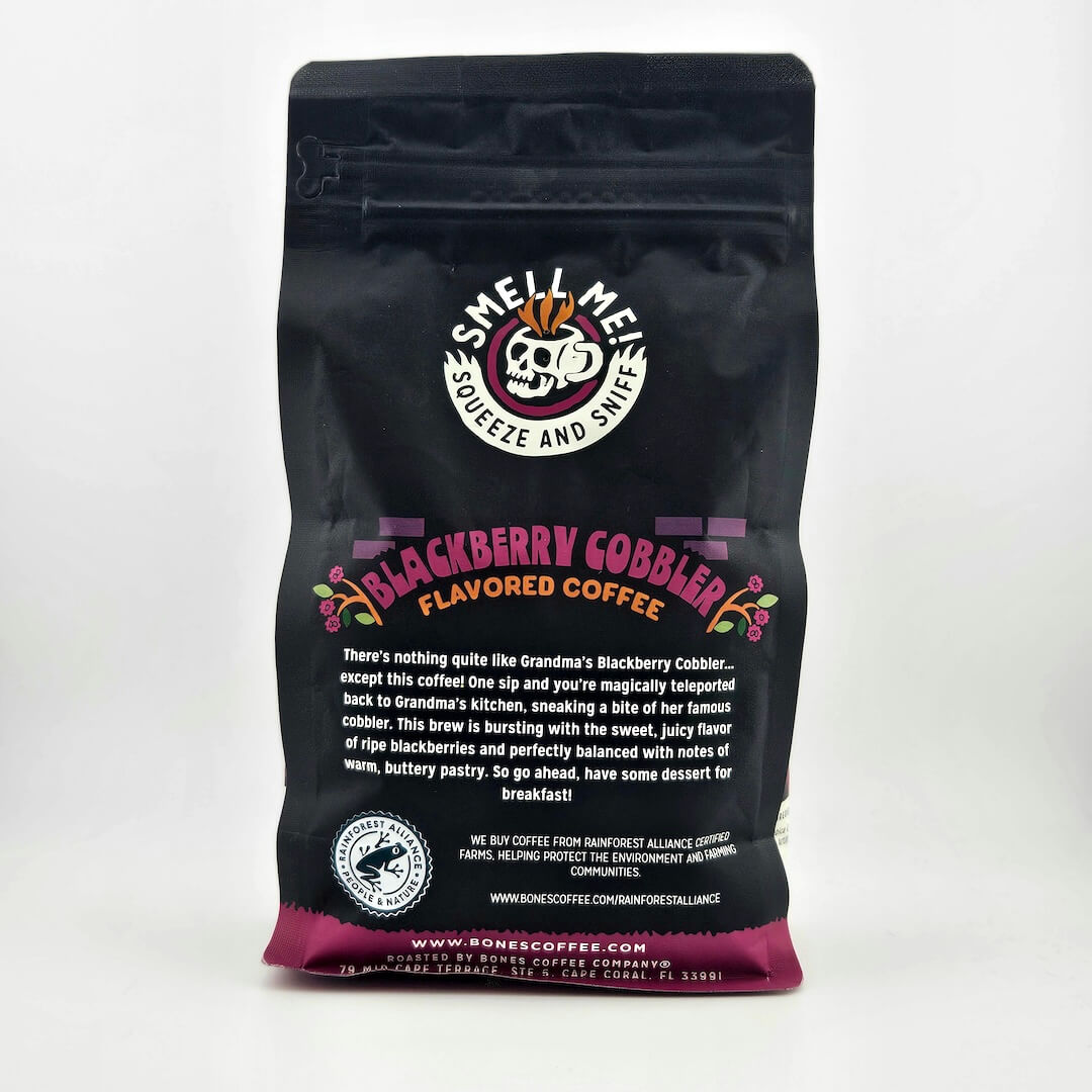 Black coffee bag with 'Smell Me! Squeeze and Sip!' branding and 'Blackberry Cobbler' flavor description on a white background.