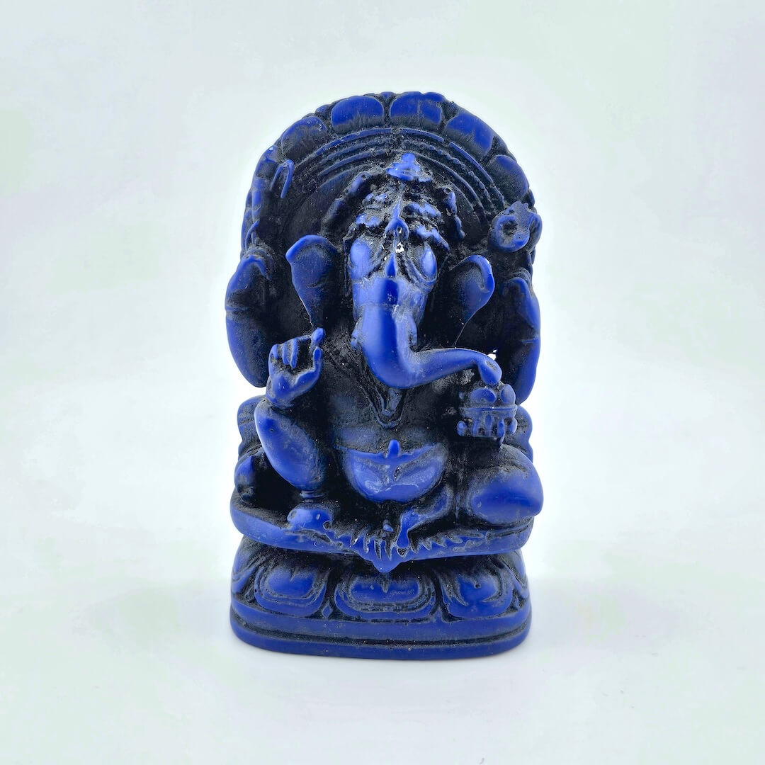 Blue statue of a seated figure on a white background