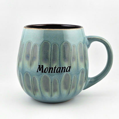 Blue ceramic mug with 'Montana' text on a white background