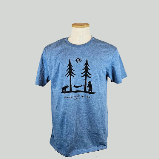Blue t-shirt with black tree & hammock graphic design on a mannequin against a white background