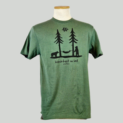 Green t-shirt with two trees and a hammock above text "breakfast in bed, Montana"