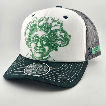 White face trucker hat with green mesh & bill featuring green stamp looking smiling man's head with trees for hair. 