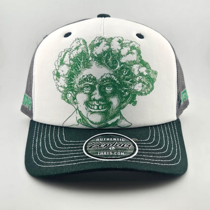 White face trucker hat with green mesh & bill featuring green stamp looking smiling man's head with trees for hair. 