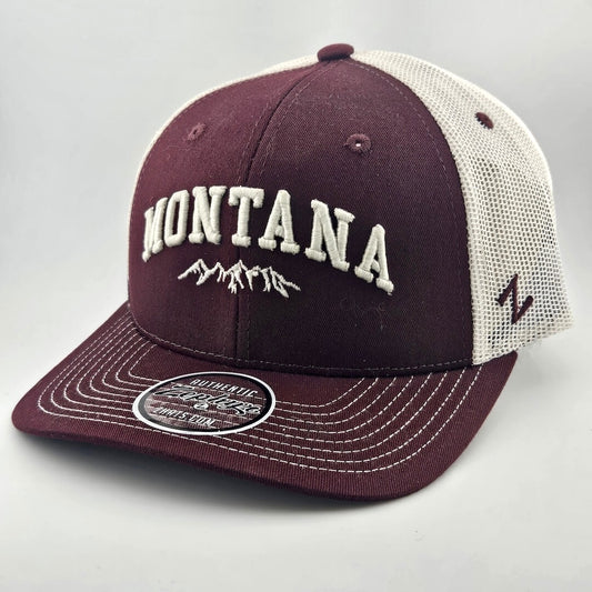 Maroon face & billed hat, white mesh back & stitching. "MONTANA" embroidered able mountain range silhouette. Sticker on brim.