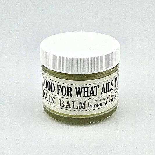 Short glass jar with white plastic lid and white label with black print.