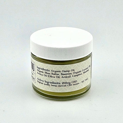 Short glass jar with white plastic lid and white label with black print.