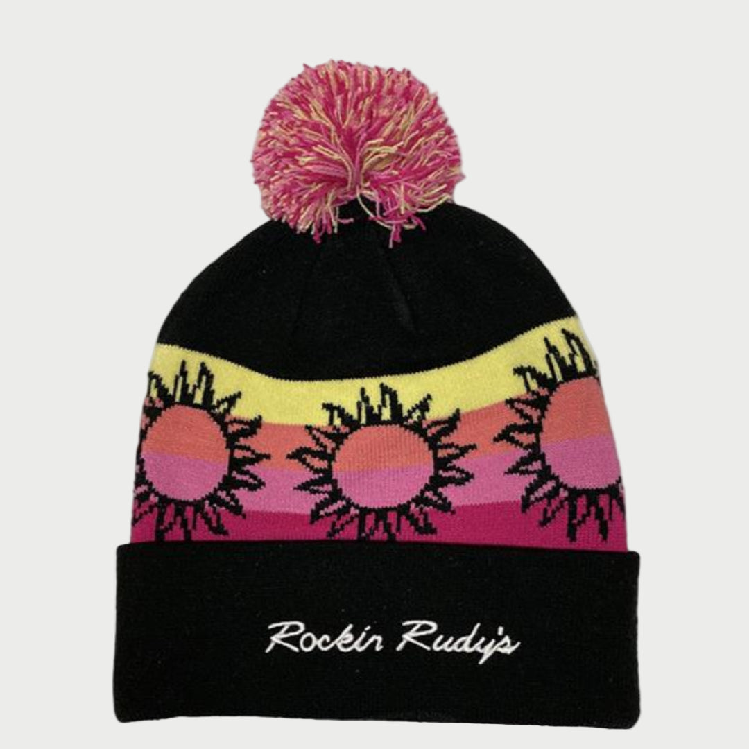 Black beanie with tricolor stripe across head with three suns. Multicolor pom at top, "Rockin Rudy's" embroidered across cuff.