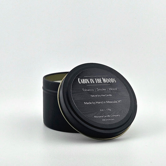 Black candle tin labeled with scent name, listed scent components, company & manufacturing information below.