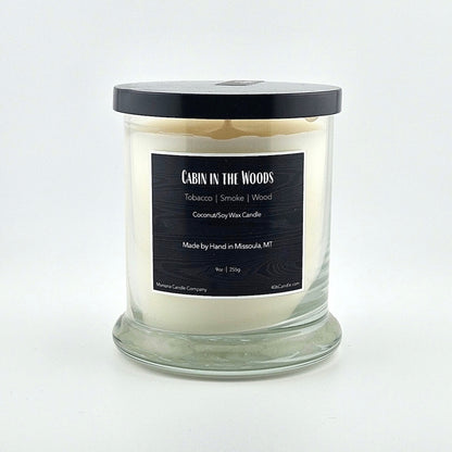 Glass jarred candle with black lid, label with printed scent name at top then listed scent components then more details below