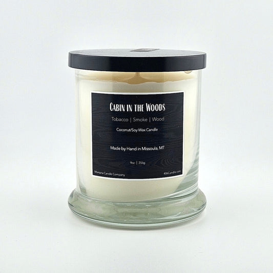 Glass jarred candle with black lid, label with printed scent name at top then listed scent components then more details below