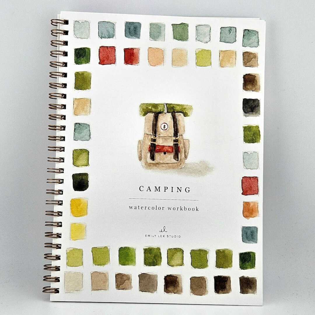 Notebook with watercolor design of a backpack and color swatches on a white background