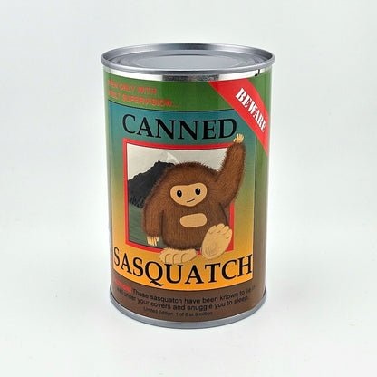 Can with colored label with black print title, simplified image of Sasquatch in center. 