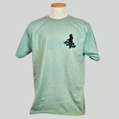 Green t-shirt with bear graphic on a mannequin against a light background