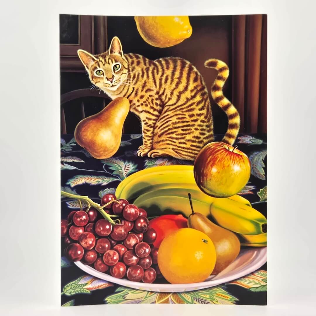 Cat sitting among fruits on a tablecloth with a window in the background