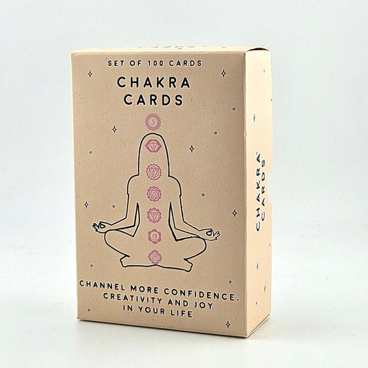 Box of Chakra Cards with a meditating figure and chakra symbols on a beige background
