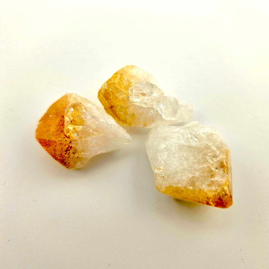 Yellow and clear crystals against white background. 
