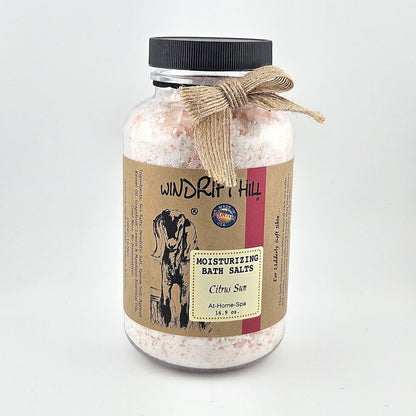 Jar of Windrift Hill bath salts with a decorative ribbon on a gray background